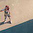 Frau in Sportkleidung steht in der Sonne und trinkt nach dem Sport 