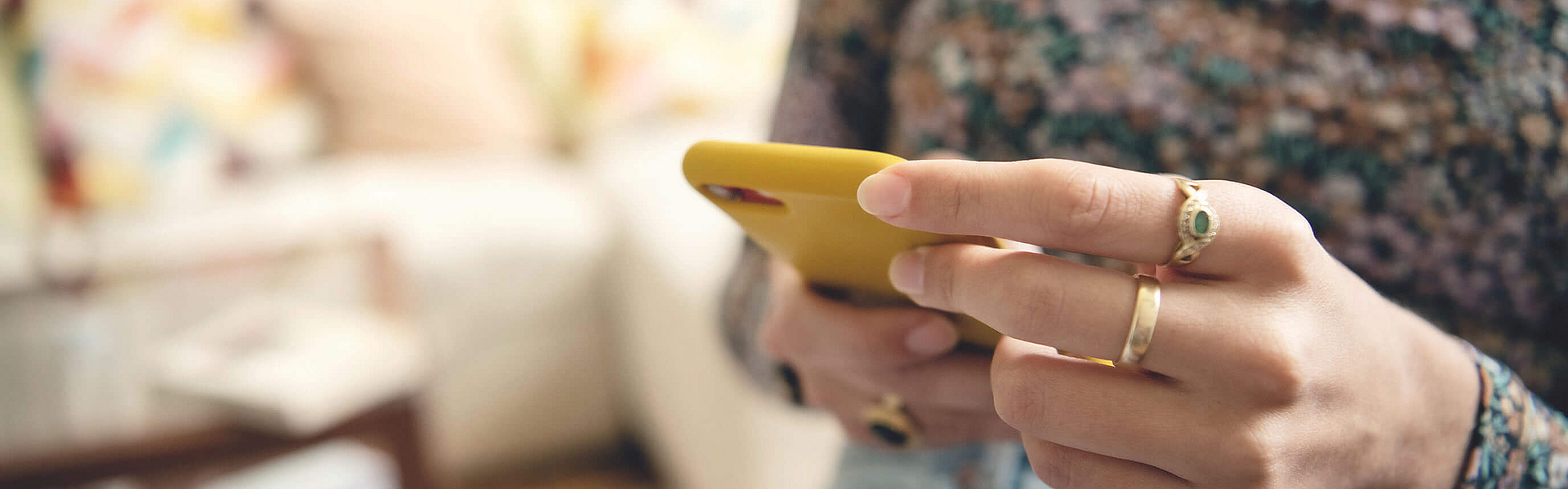 Man sieht nur das Smartphone, eine Frau tippt auf dem Display.