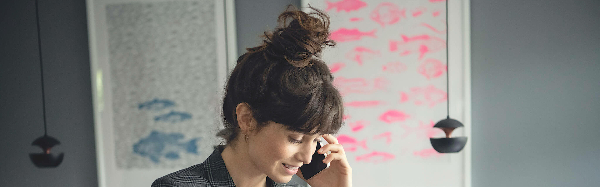 Geschäftsfrau sitzt im Büro und telefoniert.
